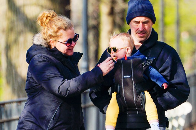 Amy Schumer and husband Chris Fischer take their son, Gene, for a stroll through New York City.