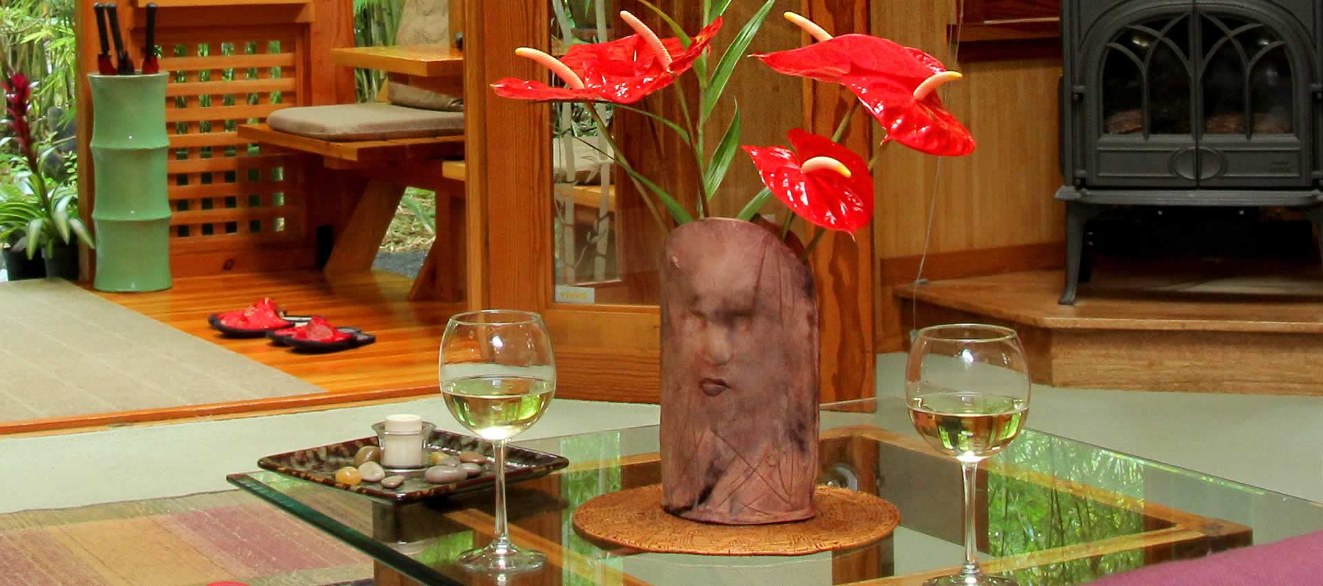 Table with wine glasses for guests and centerpiece with anthurium flowers