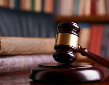 Judge's gavel on wooden table with law books. (bigstockphoto.com)