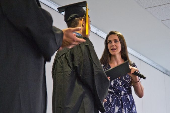 Advisor Kate Wand celebrates student Marquis Young. (Kimberly Paynter/Keystone Crossroads)