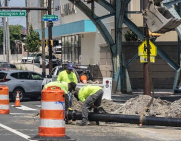 Construction workers work in the heat on Kensington Avenue