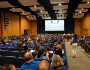 Great Valley Education Association President Nikki Salvatico walks down the aisle in the auditorium after ushering the other teachers in. (Kenny Cooper/WHYY News)