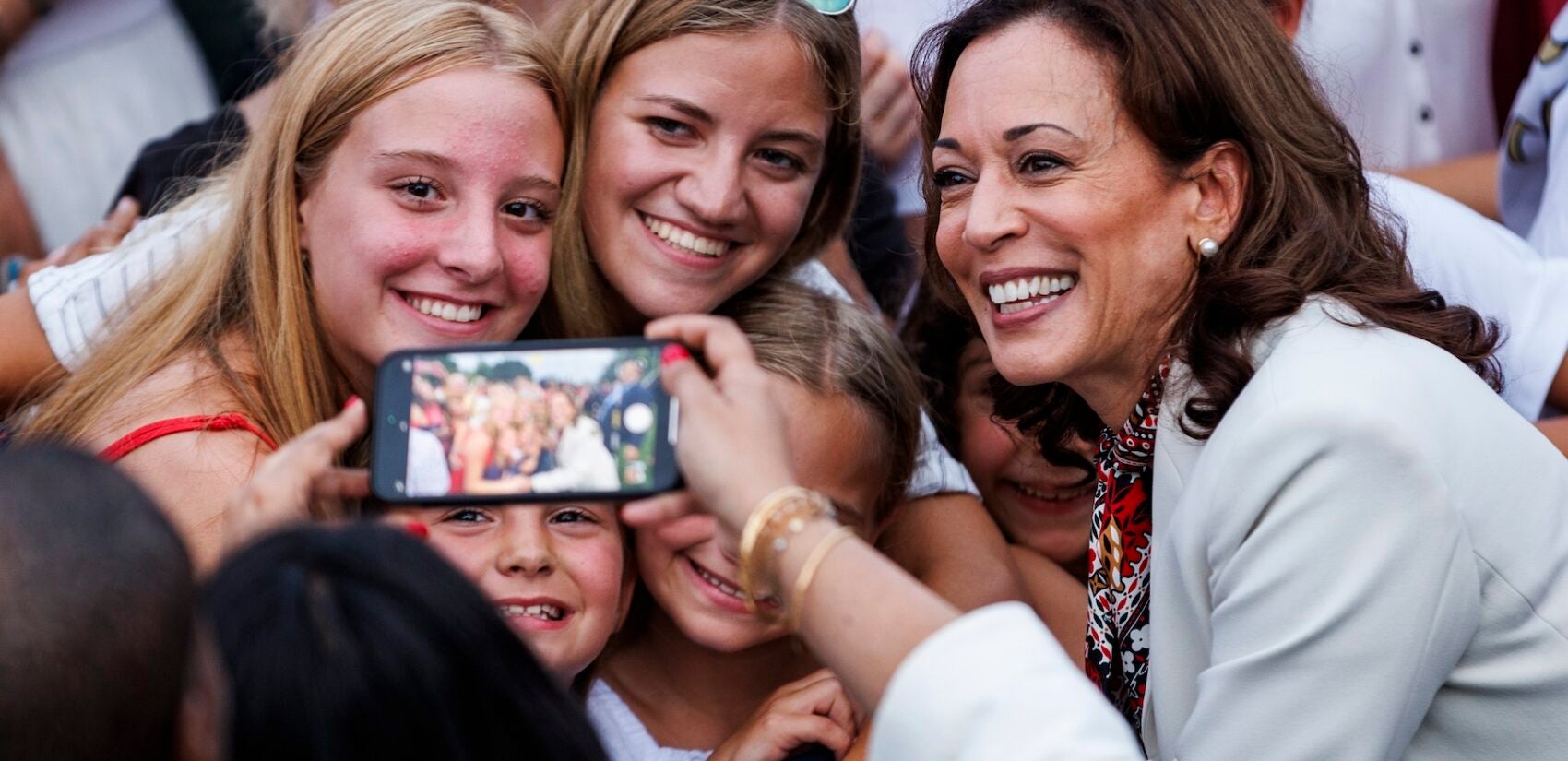 Kamala Harris posing for a photo with young women