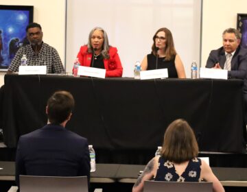 4 candidates sitting at table for debate