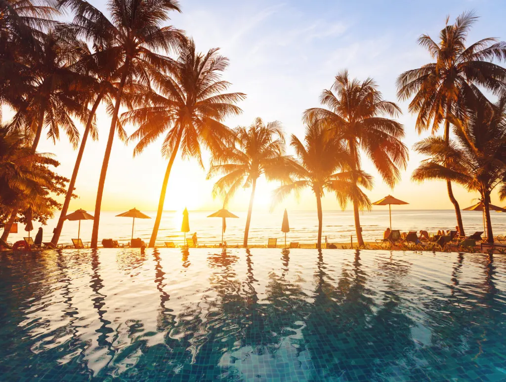 luxury swimming pool on the beach, tranquil scene of exotic tropical landscape with copy space, summer background for vacation holidays