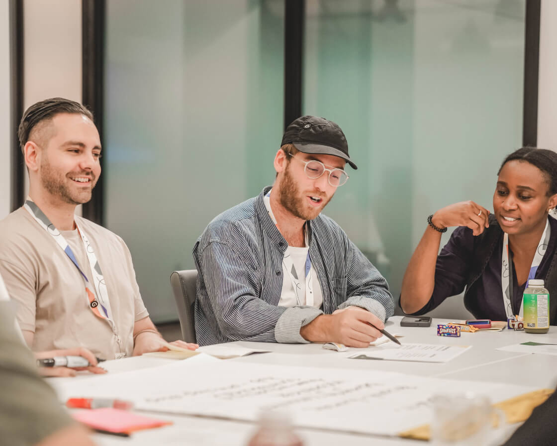 Workleap employees working together around a table.