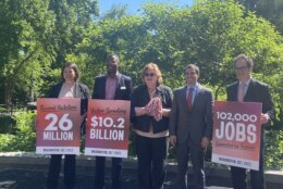 dc tourism announcement people carrying signs showing recordbreaking numbers