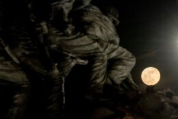 The full "Strawberry moon" is seen past the US Marine Corps War Memorial in Arlington, Virginia, on June 14, 2022. (Photo by Stefani Reynolds / AFP) (Photo by STEFANI REYNOLDS/AFP via Getty Images)