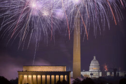 Fireworks burst above the National Mall, and from left, the Lincoln Memorial, Washington Monument and the U.S. Capitol building during Independence Day celebrations on Thursday, July 4, 2024 in Washington. (AP Photo/Mark Schiefelbein)