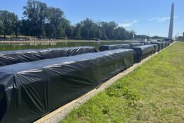 Fireworks are set up along the Lincoln Memorial Reflecting Pool ahead of the July Fourth fireworks display put on by Garden State Fireworks. (WTOP/Nick Iannelli)