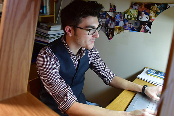 A student works on the computer in a residence hall.