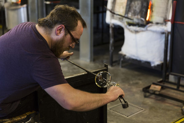 Student works on a glass blowing in CVA
