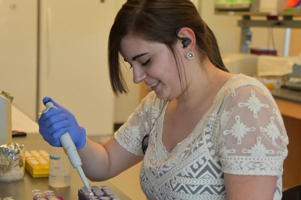 A female student works in a lab during the 2019 Summer Undergraduate Research Experience (SURE)