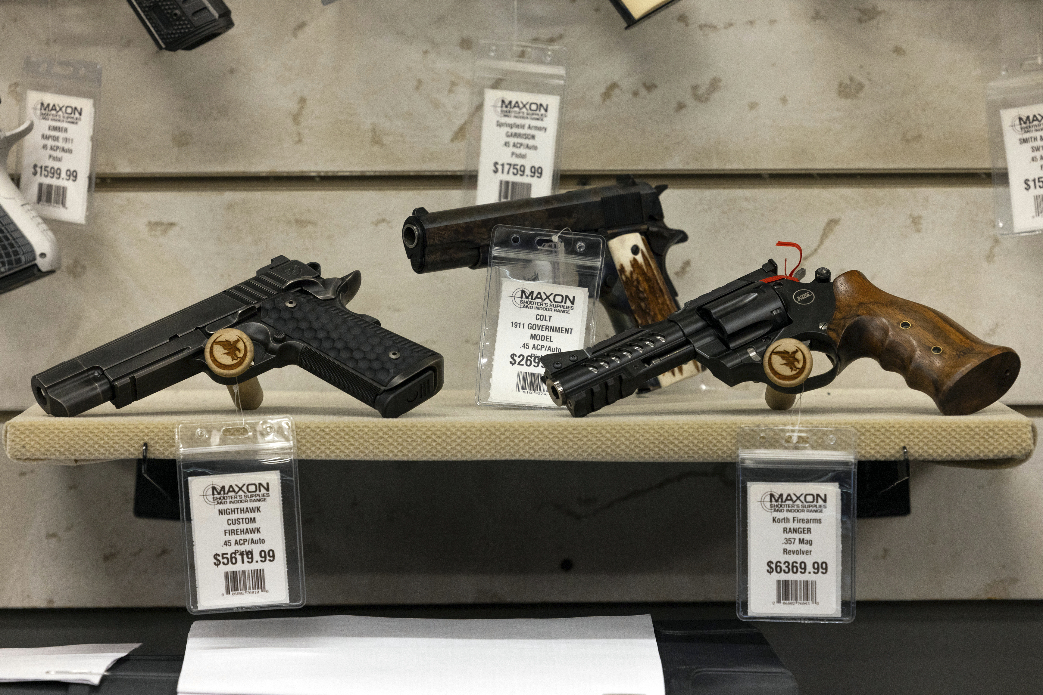 Guns for sale are displayed at Maxon Shooter's Supplies in Des Plaines, Ill., Tuesday, June 25, 2024. A new national divide is emerging among states over whether to track sales by gun stores. A California law taking effect Monday will require credit card networks to provide banks with special retail codes to assign to gun stores. By contrast, new laws taking effect in Georgia, Iowa, Tennessee and Wyoming will prohibit the use of special gun shop codes in financial transactions. A total of 17 states have passed some sort of limit on category codes for gun retailers, while California has been joined by Colorado and New York. (AP Photo/Teresa Crawford)