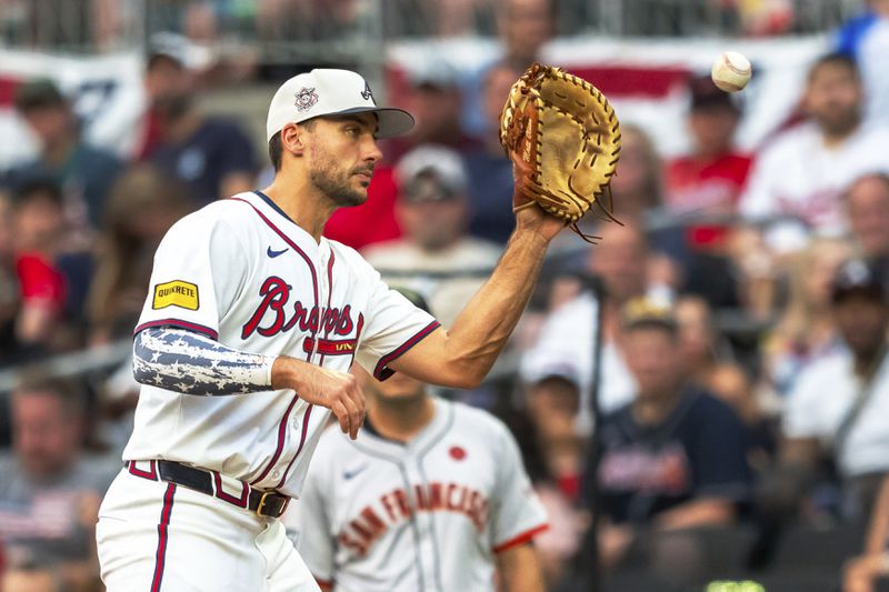 Atlanta Braves first base Matt Olson tags a runner at first base during the fifth inning of a baseball game against the San Fransisco Giants, Thursday, July 4, 2024, in Atlanta. (AP Photo/Jason Allen)