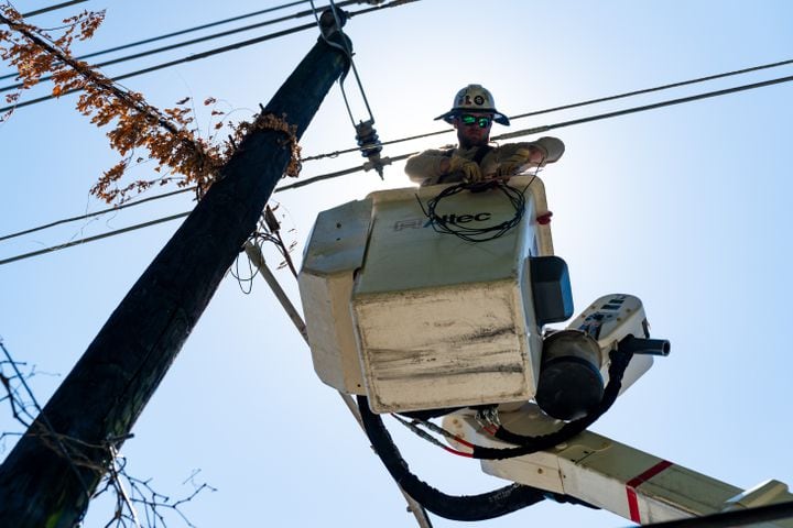 A Fairway Electric Inc. worker conducts maintenance on a telephone pole in Atlanta on Monday, June 24, 2024. (Seeger Gray / AJC)
