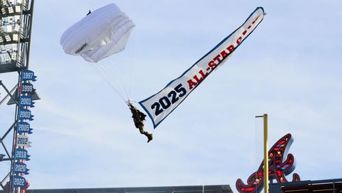 A parachute enters Truist Park during the ceremonies for unveiling the All-Star Game logo on Monday, July 22, 2024, in Atlanta. 
(Miguel Martinez/ AJC)