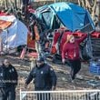 Atlanta Police and GDOT personnel clear a homeless encampment Monday.