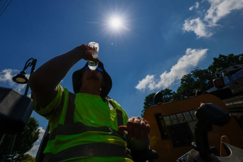 Construction worker Daren True is spotted drinking water as temperatures soared in Metro Atlanta on Monday, June 24, 2024. The heat index is likely to soar past 100 degrees in the next few days.
(Miguel Martinez / AJC)