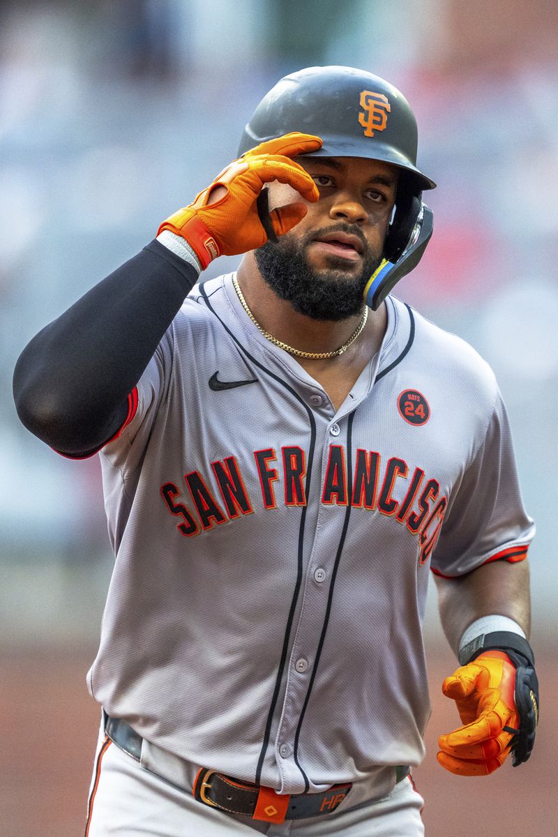 San Francisco Giants Heliot Ramos salutes to the crowd after hitting a home run to center field during the fourth inning of a baseball game against the Atlanta Braves, Thursday, July 4, 2024, in Atlanta. (AP Photo/Jason Allen)