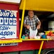 Melvin Self bags some fruit for a customer at Melvin's Produce, which sits just off Exit 142 on I-75 along Georgia 96 in Middle Georgia's Peach County. (Joe Kovac Jr. / AJC)