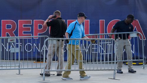 Unintes States Secret Service officers move baricades outside the Fiserv Forum ahead of the 2024 Republican National Convention, Saturday, July 13, 2024, in Milwaukee. Former president Donald Trump was whisked off the stage at a rally in Butler, Pennsylvania after apparent gunshots rang through the crowd. (AP Photo/Alex Brandon)