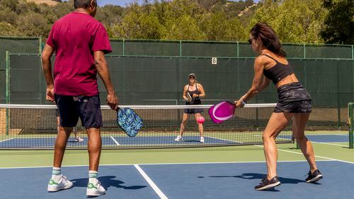 
                        FILE -- Playing pickleball at a tennis club in Fairfax, Calif., Aug. 15, 2022. If pickleball is your main form of exercise, you may need to augment it. There are moves you need to add to age well and avoid injury. (Christie Hemm Klok/The New York Times)
                      