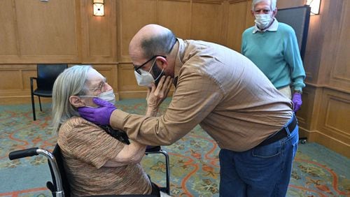 Connie Kendrick and her son, William Kendrick, embrace as they see each other at The William Breman Jewish Home in Atlanta on Thursday. (Hyosub Shin / Hyosub.Shin@ajc.com)