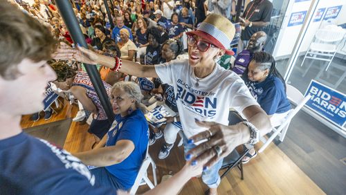 Rochelle Jackson (Right) gives Parker Short, the president of Georgia Young Democrats, a hug after his speech at the Biden-Harris and Georgia Democrats for DeKalb County Office Opening in Decatur on Saturday, July 6, 2024. (Steve Schaefer / AJC)