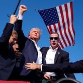  Donald Trump, surrounded by Secret Service, after a shooting happened at a campaign rally. AP Photo/Evan Vucci 