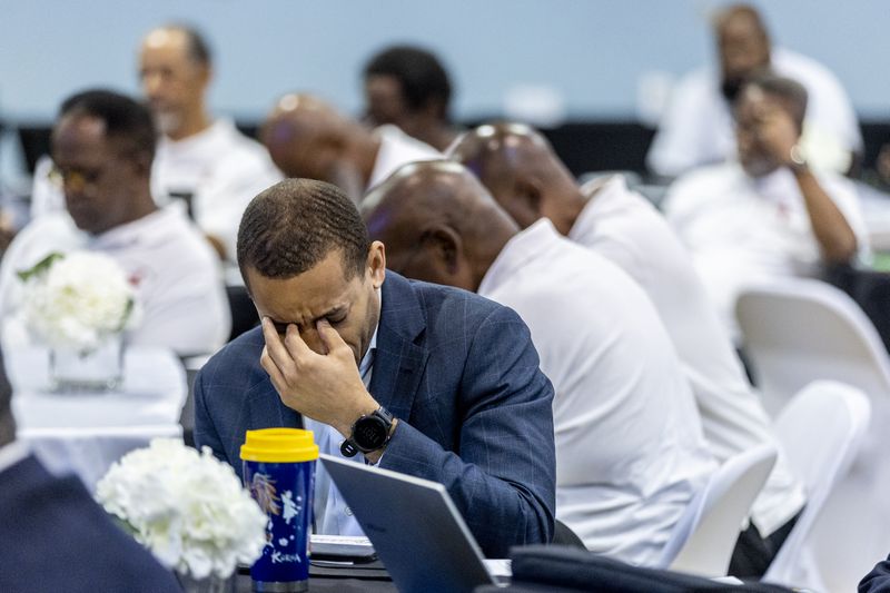 Participants pray during the opening statements at the inaugural Greater Atlanta Congress of Black Men Conference at Mt. Ephraim Baptist Church in Atlanta Saturday, July 13, 2024 (Steve Schaefer / AJC)