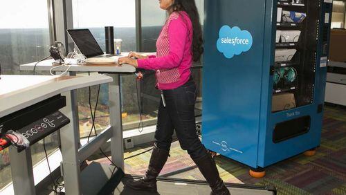 Prlya Pemmasani uses a treadmill desk, next to an IT vending machine, at Salesforce's Atlanta office. Courtesy