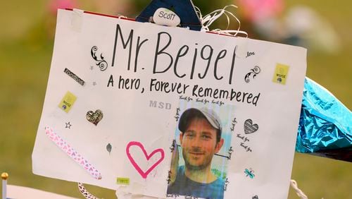 FILE - This Feb. 20, 2018, file photo shows a memorial for Geography teacher and cross-country coach, Scott Beigel at Pine Trails Park in Parkland, Fla. (Mike Stocker/South Florida Sun-Sentinel via AP, File)