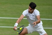 Carlos Alcaraz of Spain plays a forehand return to Novak Djokovic of Serbia during the men's singles final at the Wimbledon tennis championships in London, Sunday, July 14, 2024. (AP Photo/Mosa'ab Elshamy)