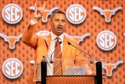 Texas head football coach Steve Sarkisian flashes the "Hook 'Em Horns" sign after speaking at the Southeastern Conference NCAA college football media days Wednesday, July 17, 2024, in Dallas. (AP Photo/Jeffrey McWhorter)