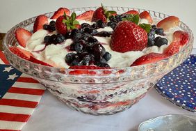 cut glass trifle bowl with layers of cake, yogurt, and berries in red, white, and blue