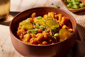 One-Pot Cheeseburger Pasta garnished with pickles, sesame seed and green onions in a bowl 