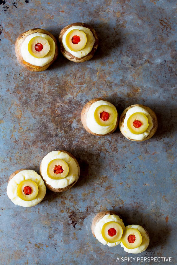 So much fun! Spooky 5-ingredient Stuffed Mushroom Eyeballs for Halloween on ASpicyPerspective.com 