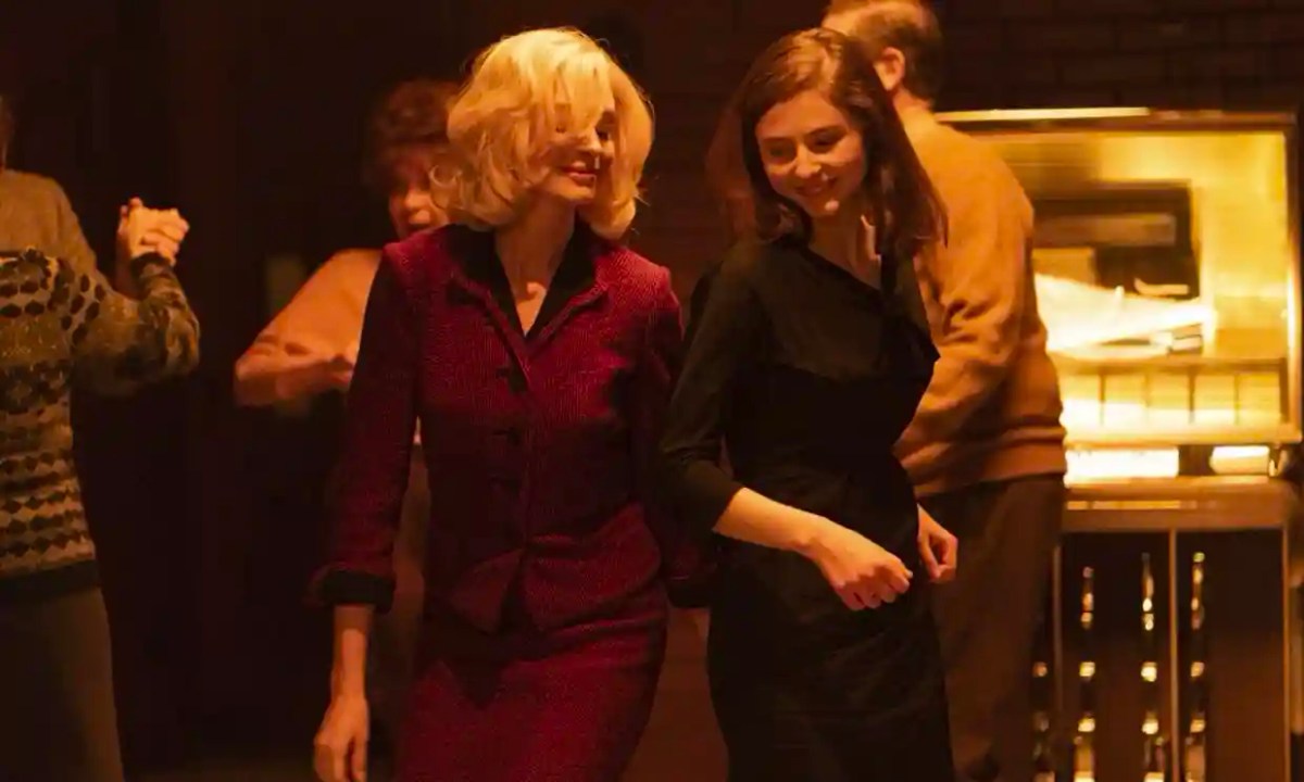 A still from "Eileen" where two women dance in a bar.