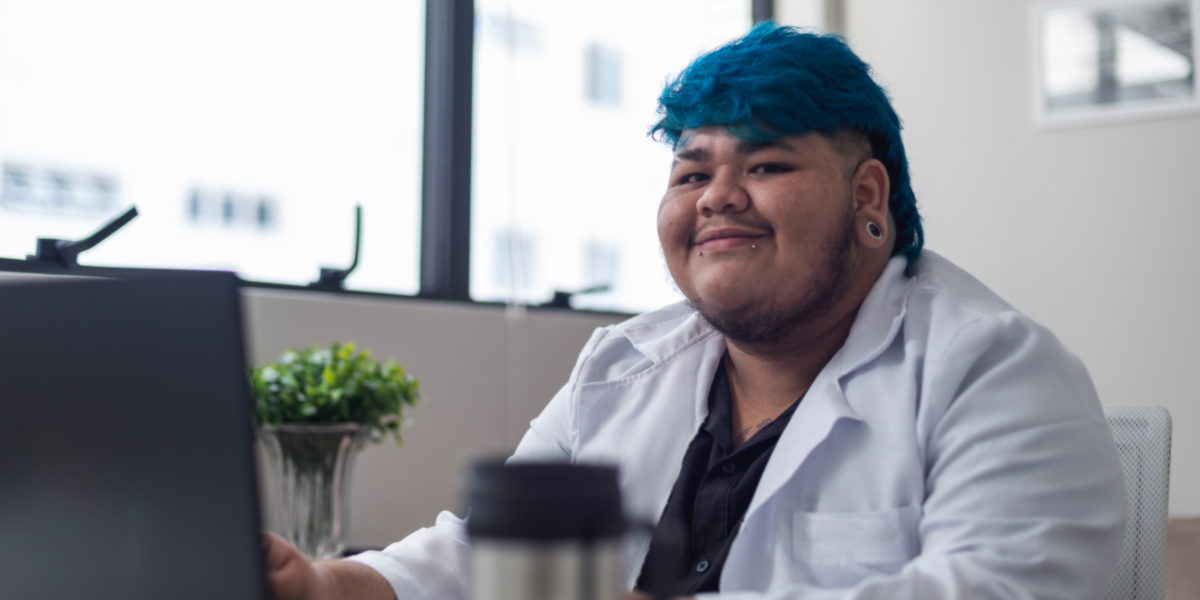 Portrait of a real male transgender healthcare professional who works in his field. He looks ready to tell you about testosterone.