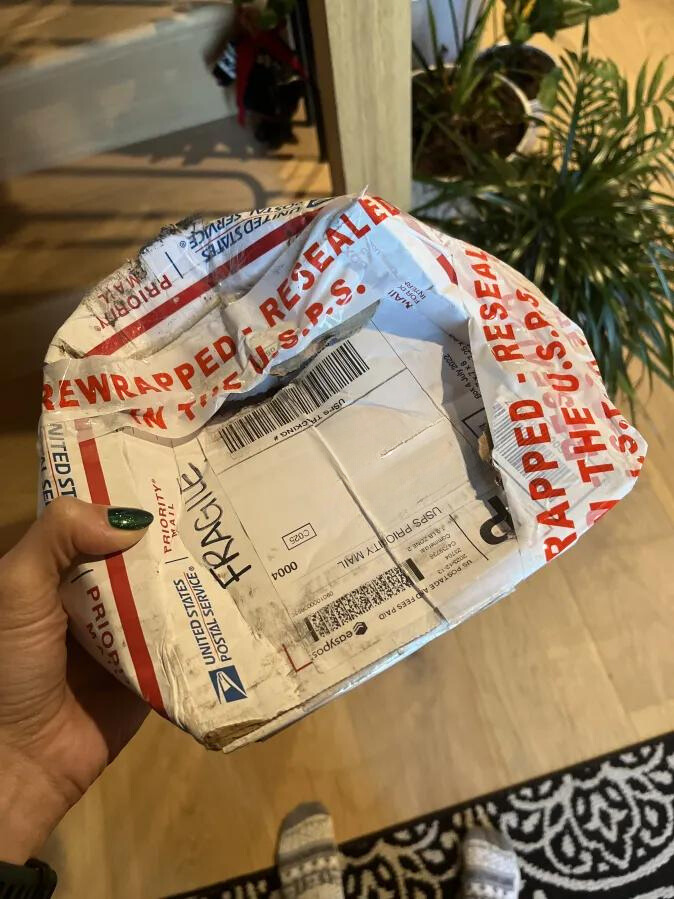 a package that looks like it was run over by a truck