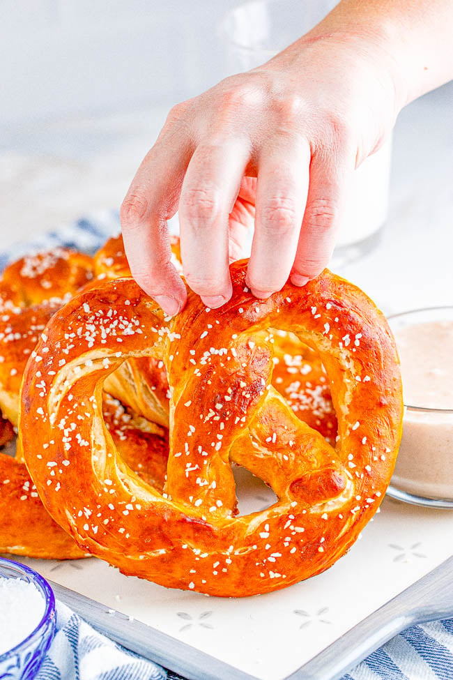 Homemade Soft Pretzels - These jumbo pretzels are soft, chewy, and just like the IRRESISTIBLE ones at your local mall's food court! Skip the mall and make these at home in ONE HOUR with this EASY to follow recipe and step-by-step photos! Whether you want to sprinkle them with coarse salt or cinnamon-sugar, these carby delights will be an automatic family FAVORITE! 