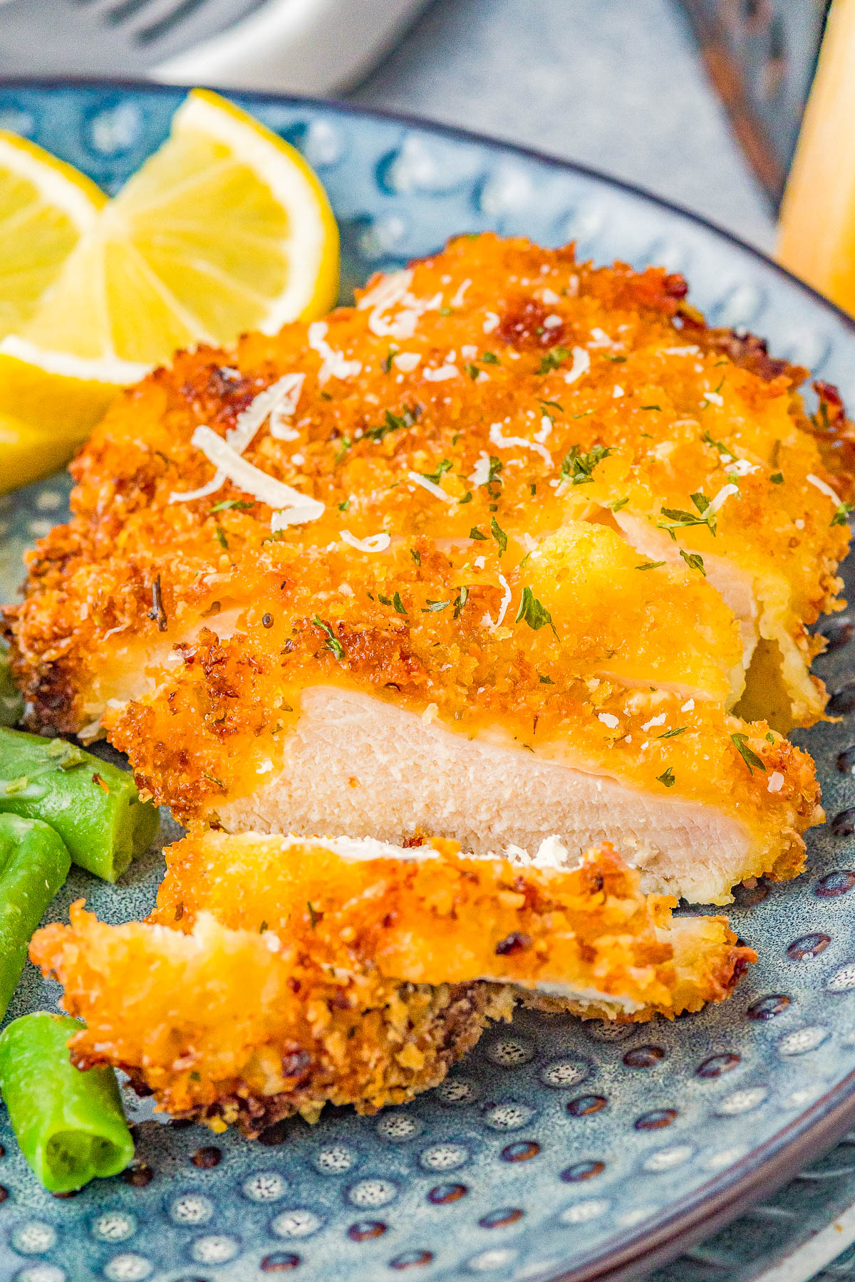 Air Fryer Parmesan Chicken - Coated in a mixture of panko bread crumbs and Parmesan cheese, this "fried" chicken is perfectly crispy on the outside and juicy, tender, and moist inside! It's EASY, ready in 15 minutes, perfect for busy weeknights, and a healthier way to indulge in fried chicken! Oven-baking instructions also provided.