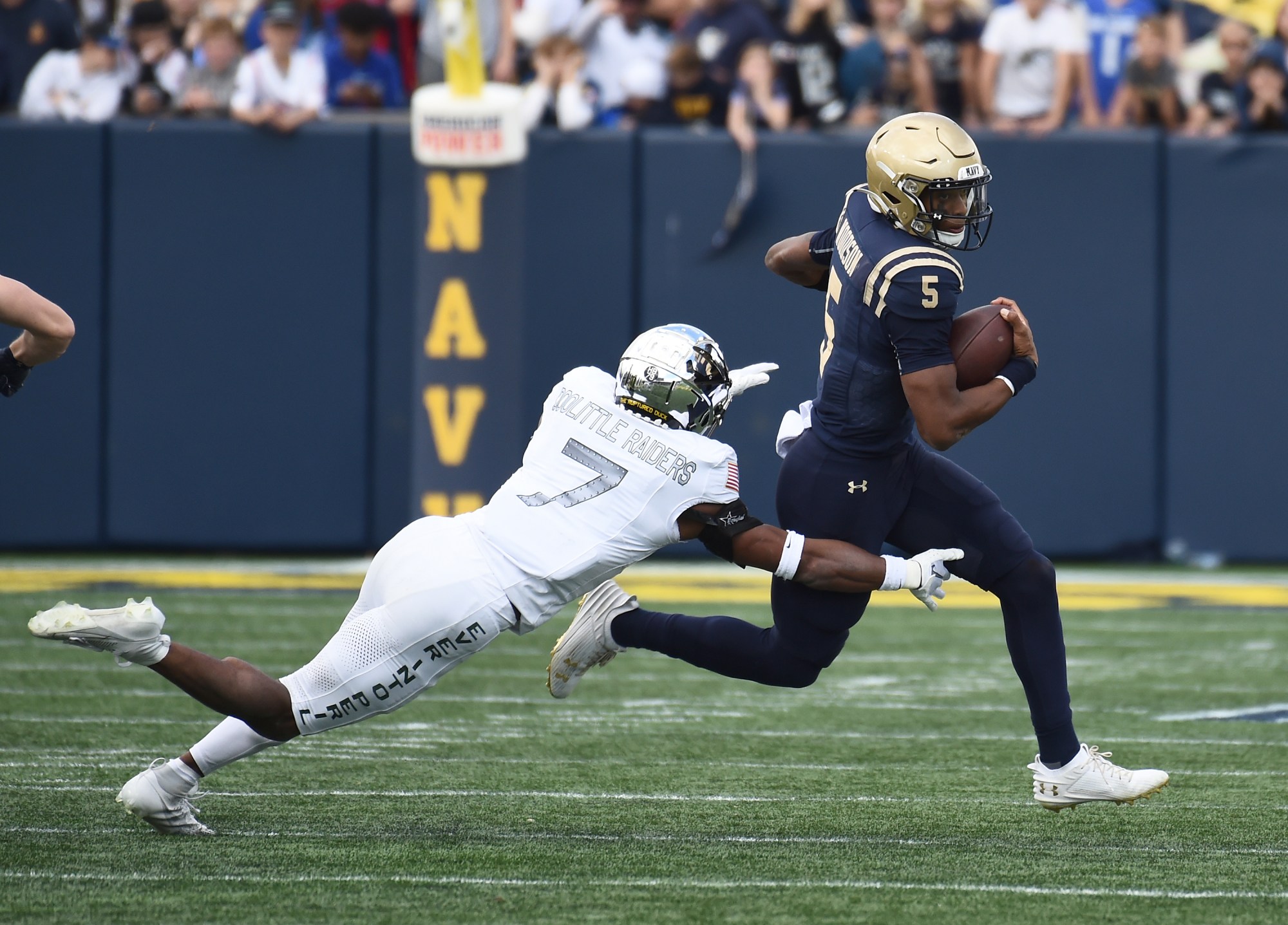 Navy quarterback Braxton Woodson gains short yards on a run in the first. quarter. The Navy Midshipmen played the visiting Air Force Falcons, in NCAA football, at Navy-Marine Corps Memorial Stadium, Saturday, October 21, 2023.