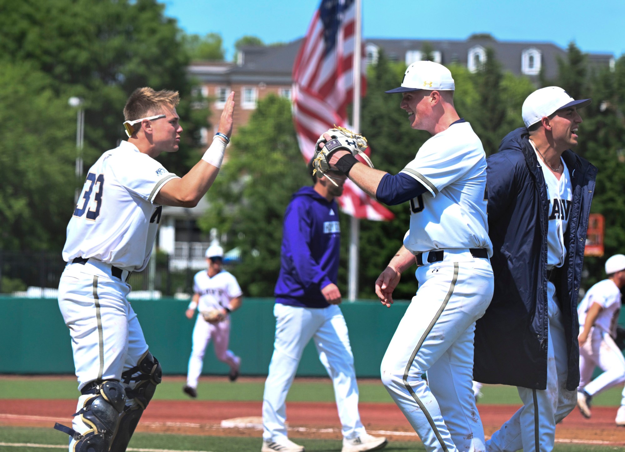 Freshman pitcher Brady Bendik is congratulated by Tristan Rucker after earning the win in Game 2 on Sunday. (Debbie Latta/Navy Athletics)