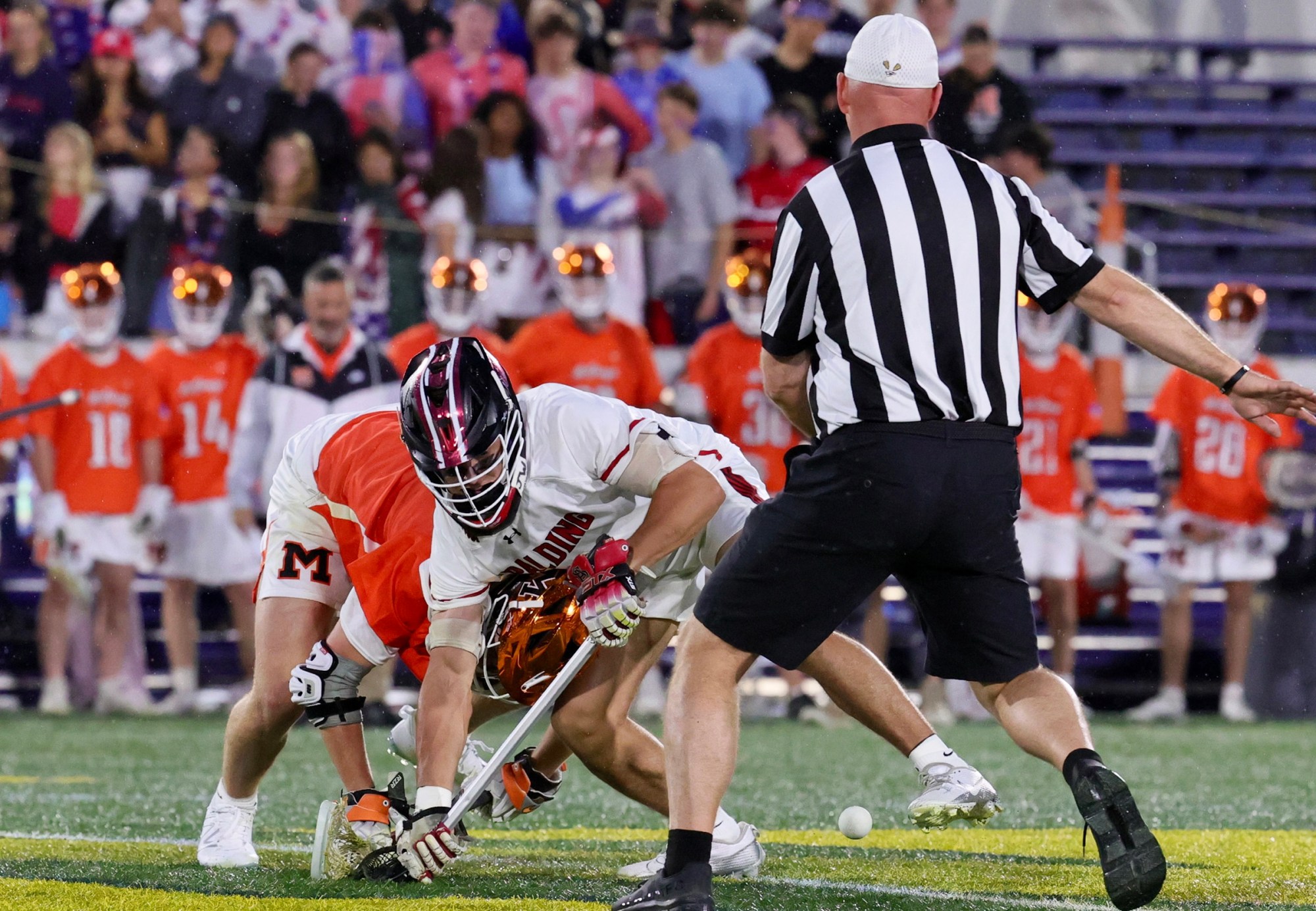 McDonogh's Ciaran Sweeney and Spalding's Ryan Criswell battle at the faceoff stripe. (John Malamphy/Courtesy photo)