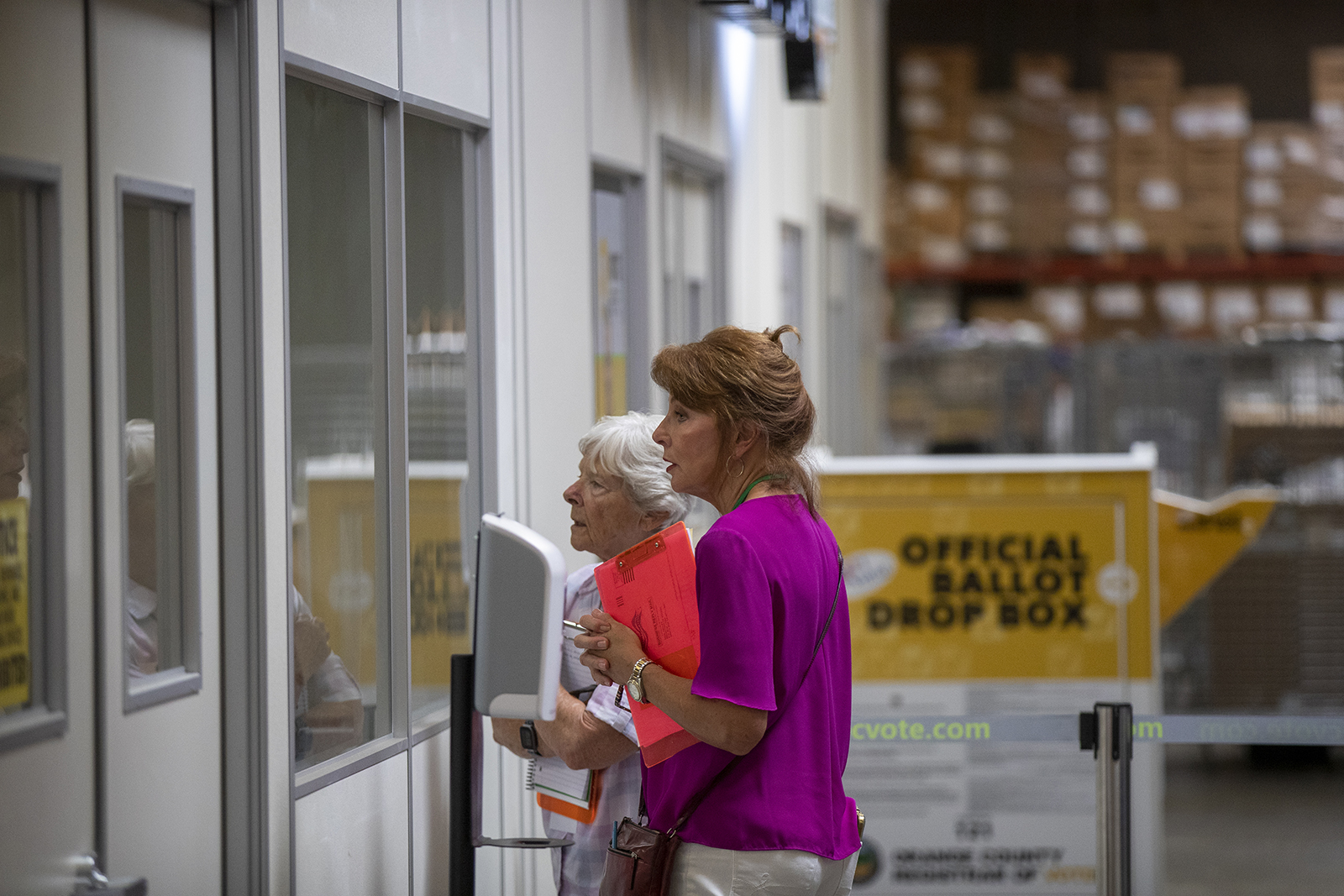 Observers from the Election Integrity Project watch ballots being processed in Orange County during California's 2021 gubernatorial recall election. (Allen J. Schaben/Los Angeles Times/TNS)