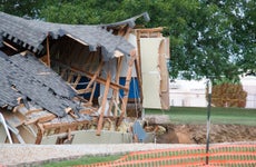 A house in shambles from a sinkhole.