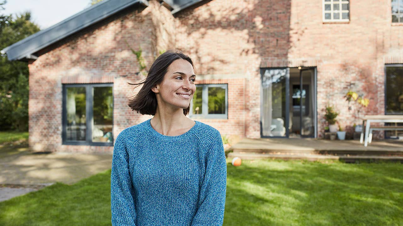 Woman standing in front of house