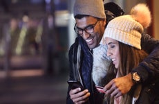 Couple checks cellphone in the cold